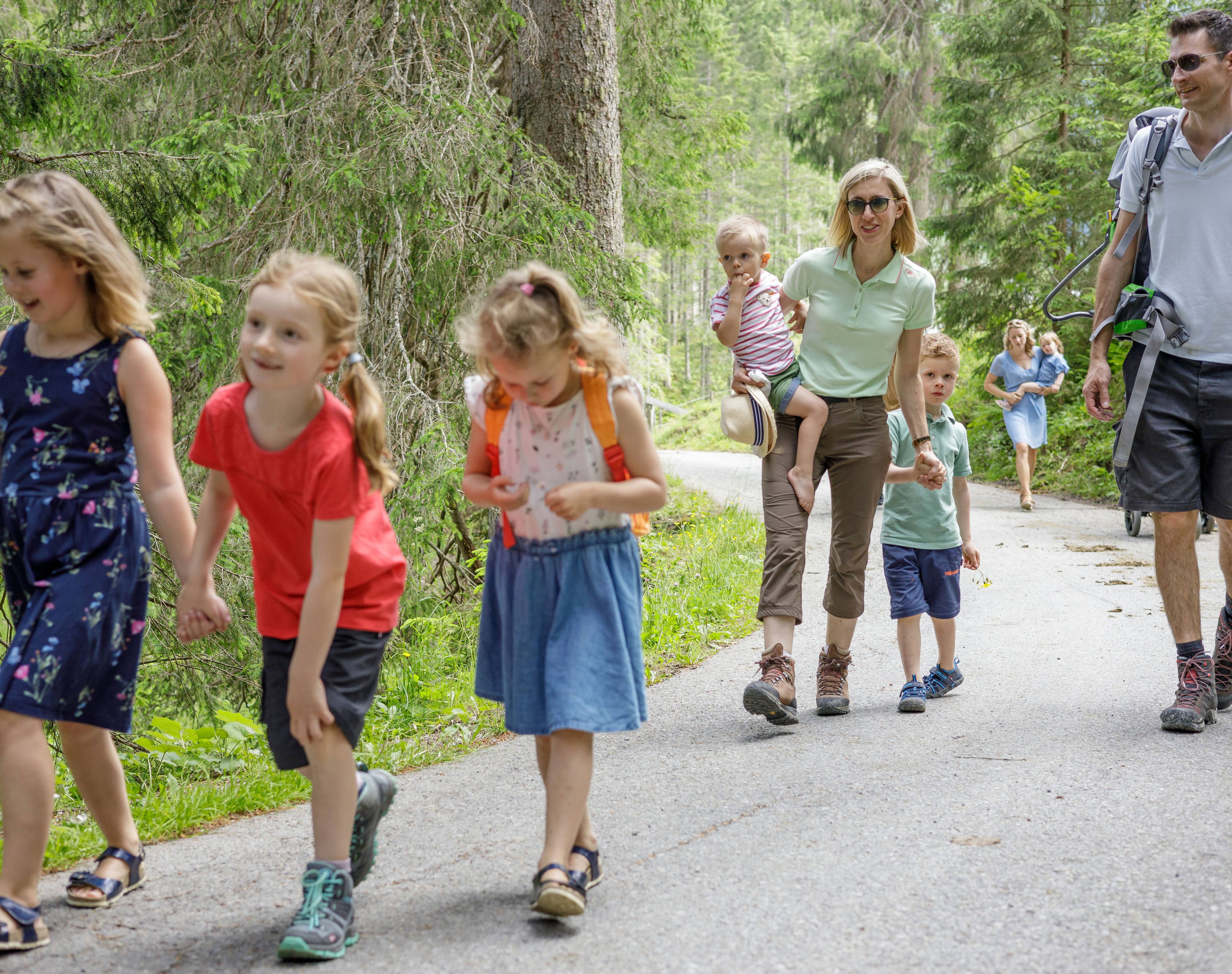 Families hiking in the forest in Tyrol