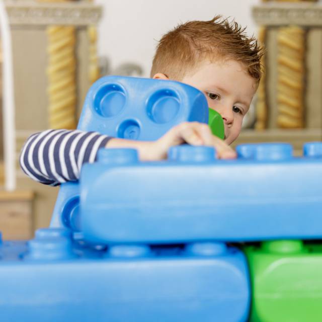 Child plays with giant Lego