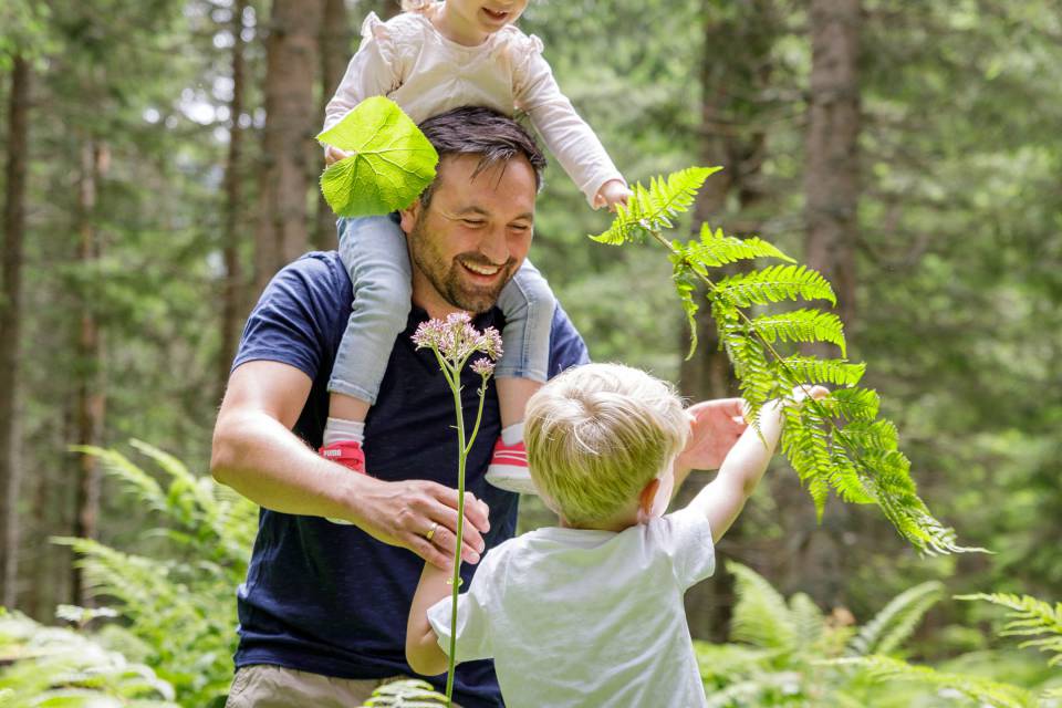 Man with two children in the forest