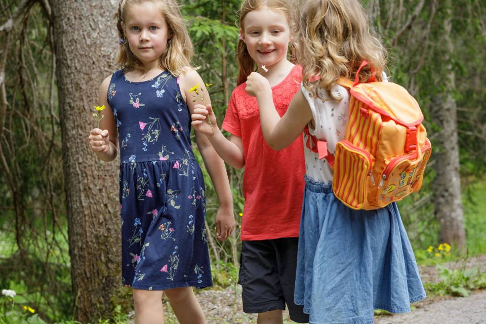 Three girls walk along the street