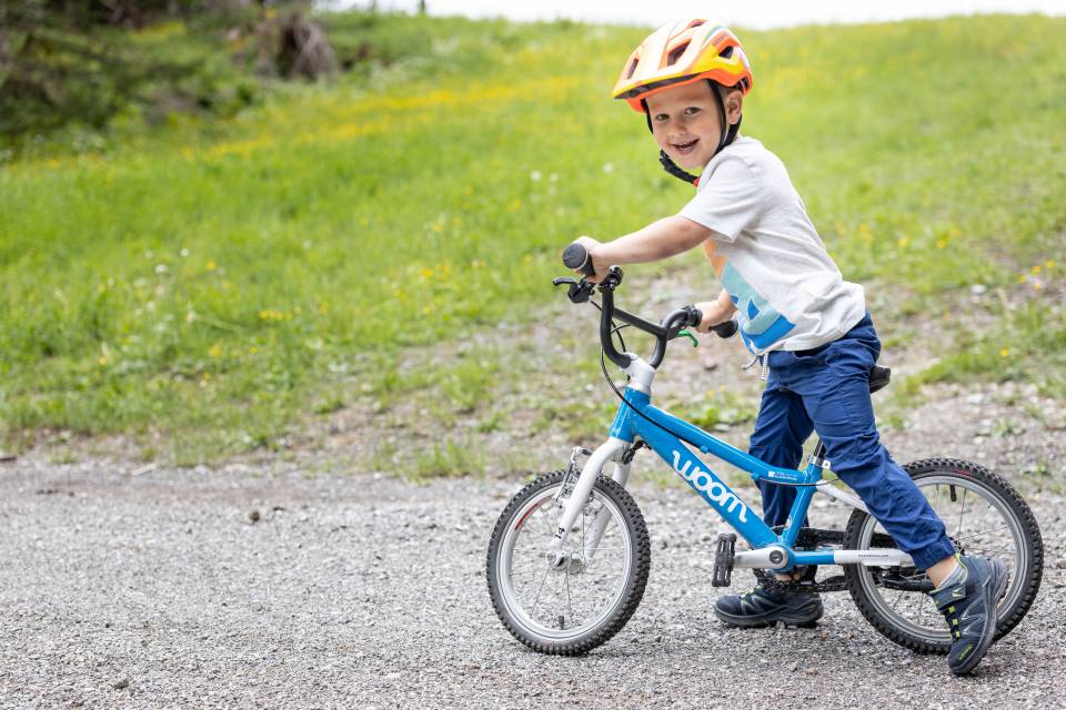 Boy standing on a balance bike