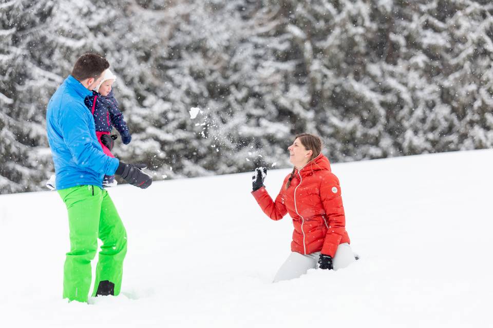 Family playing in the snow