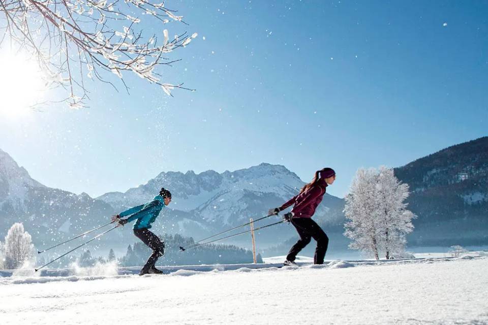 Man and woman cross-country skiing in Tyrol, Berwang