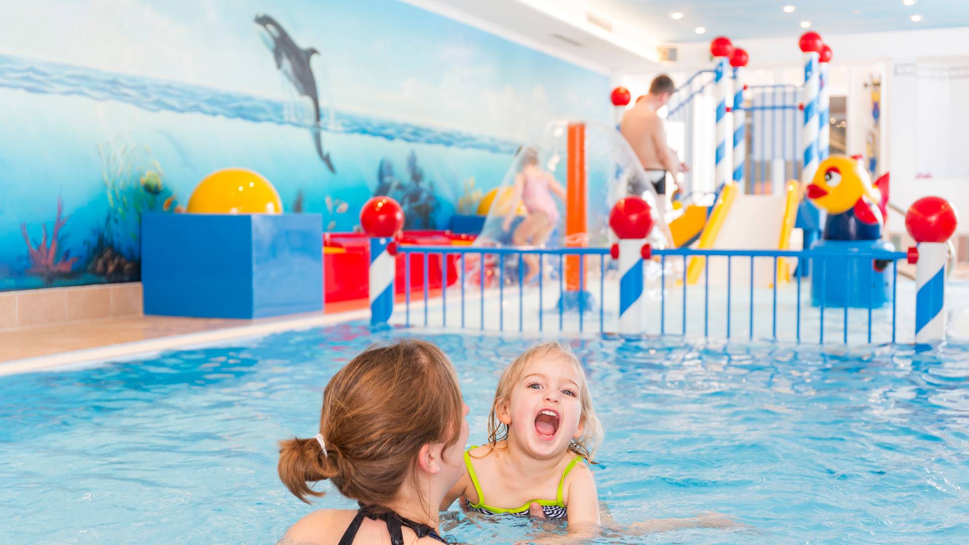 Mother with her doughter in the toddlers pool